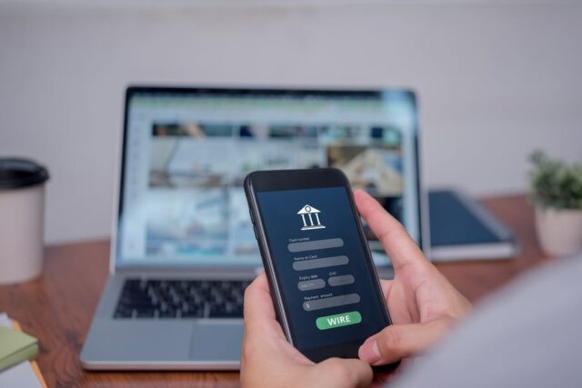 Person is using a cell phone to wire money
