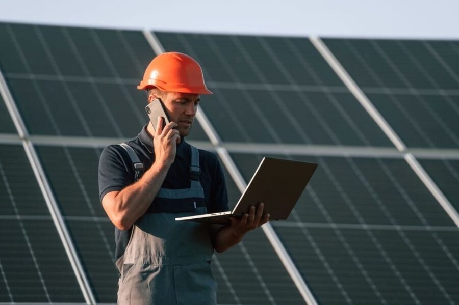 Talking by phone holding laptop man is working